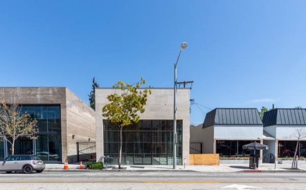 Vacant travertine storefront adjacent to Ami Paris at Melrose and Westbourne, with a For Lease sign in the glass